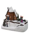 Scenario casa innevata con pista di pattinaggio funzionante a