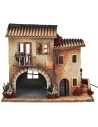 Borgo illuminato con donna in movimento per presepe Mondo